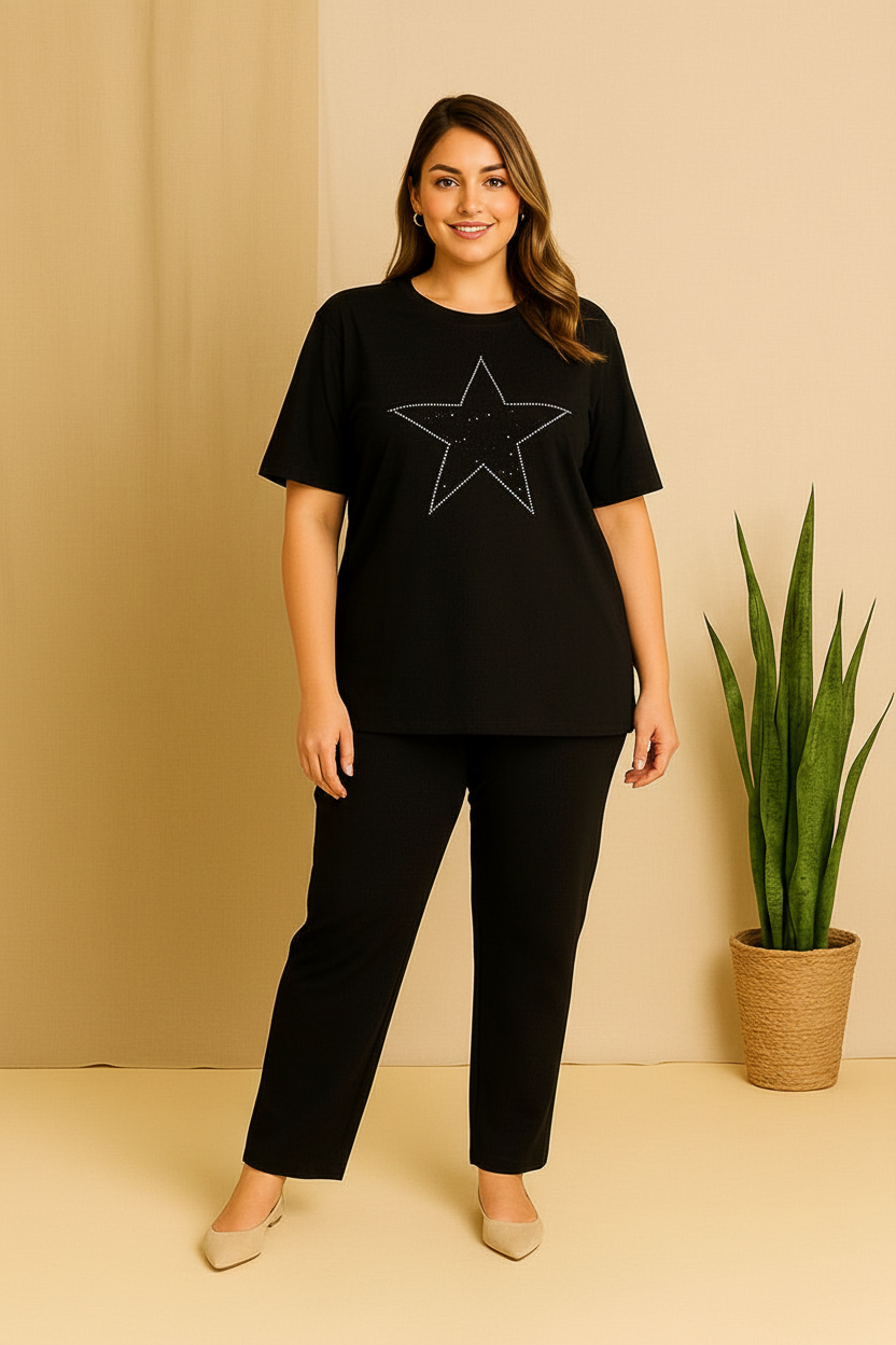 Woman wearing a black t-shirt with a star design and black pants against a beige background.