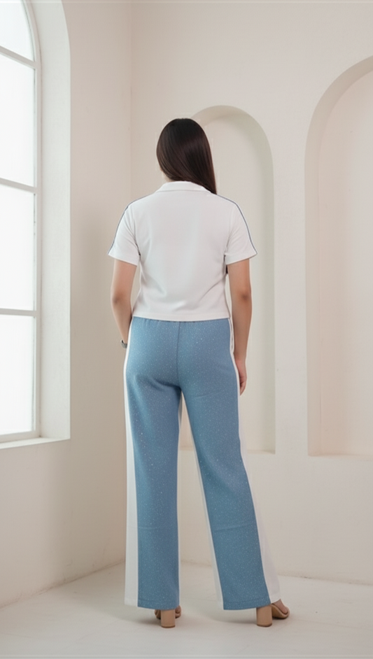 Person wearing a denim co-ord set standing in a bright, minimalistic room.