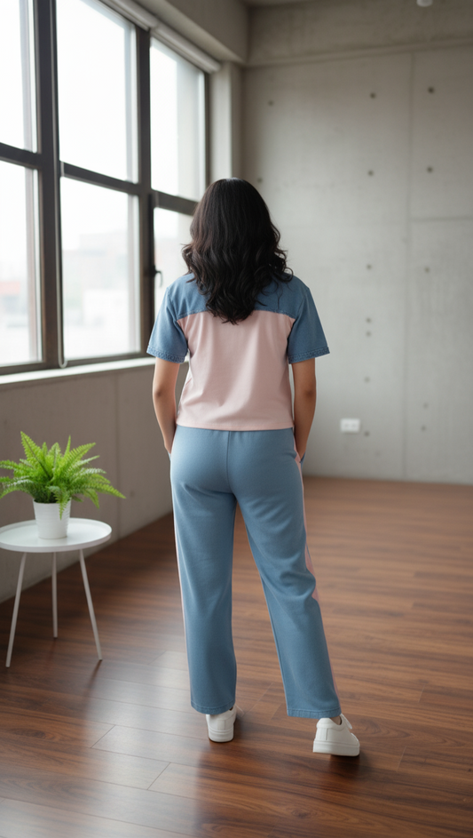 Person wearing a denim coord set in a room with large windows.