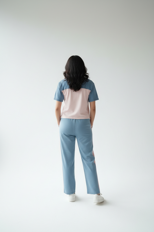 Person wearing a two-tone shirt and light blue pants on a white background