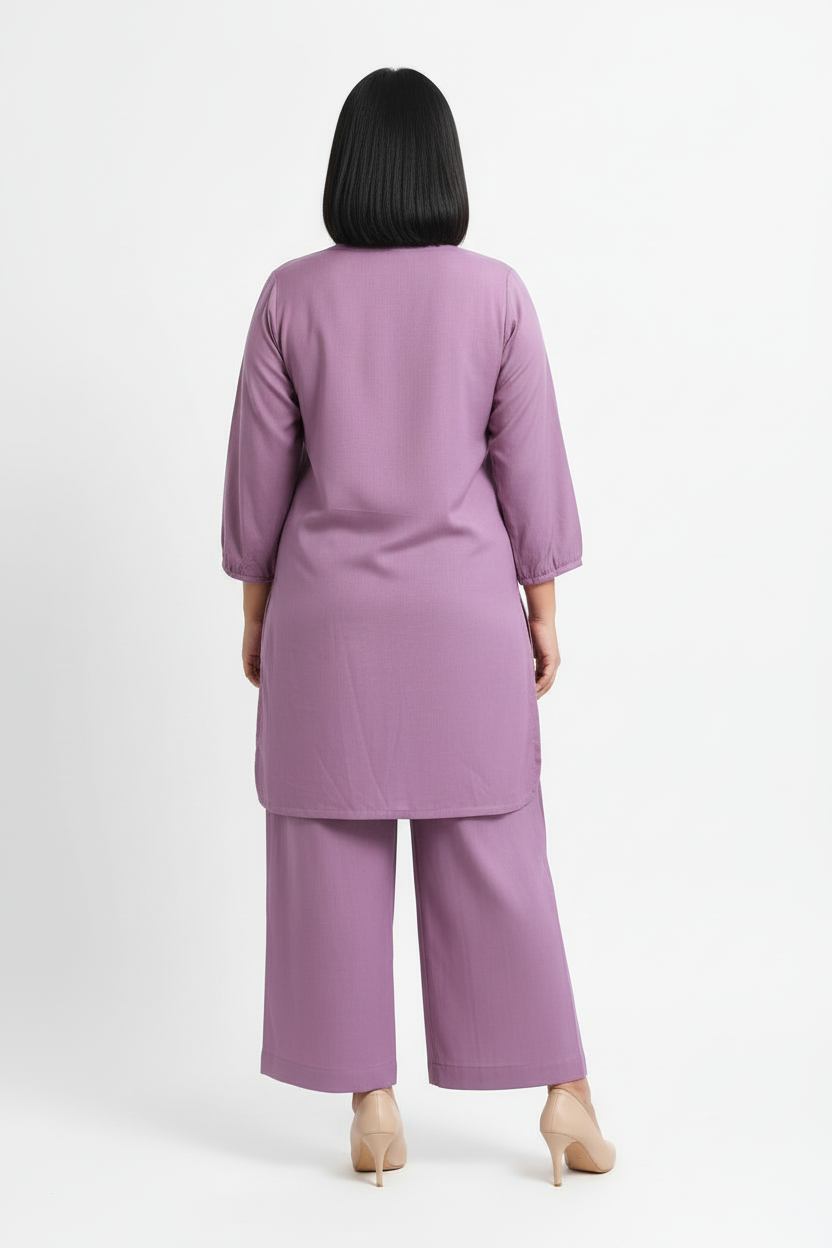 Person wearing a purple outfit on a white background