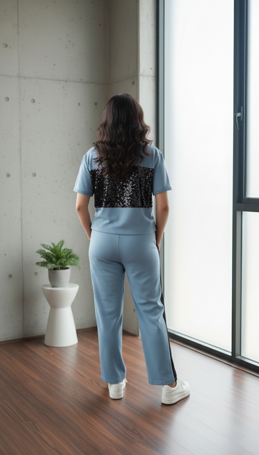 Trendy women’s denim co-ord set featuring black sequin panel top and matching straight-fit pants with side stripes.