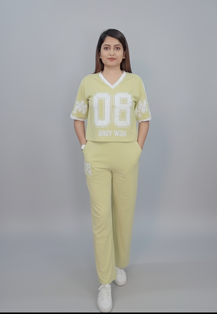 Woman wearing a light green outfit with 'DB' logo on a gray background