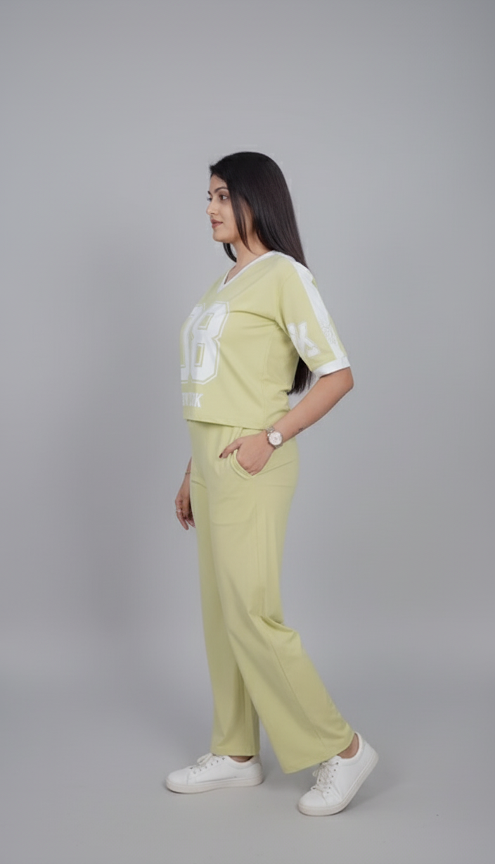 Woman wearing a light green outfit with white accents on a gray background