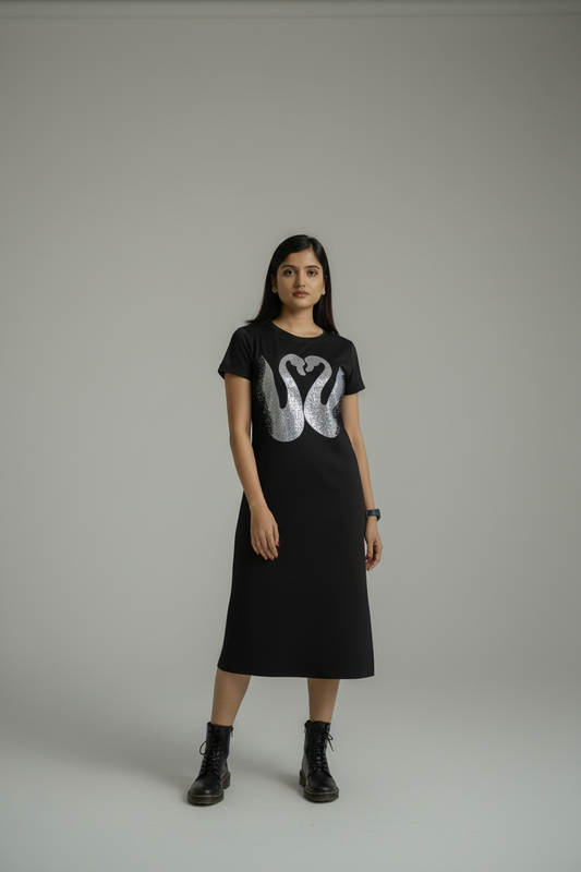 Woman wearing a black t-shirt with a white graphic design on a plain background