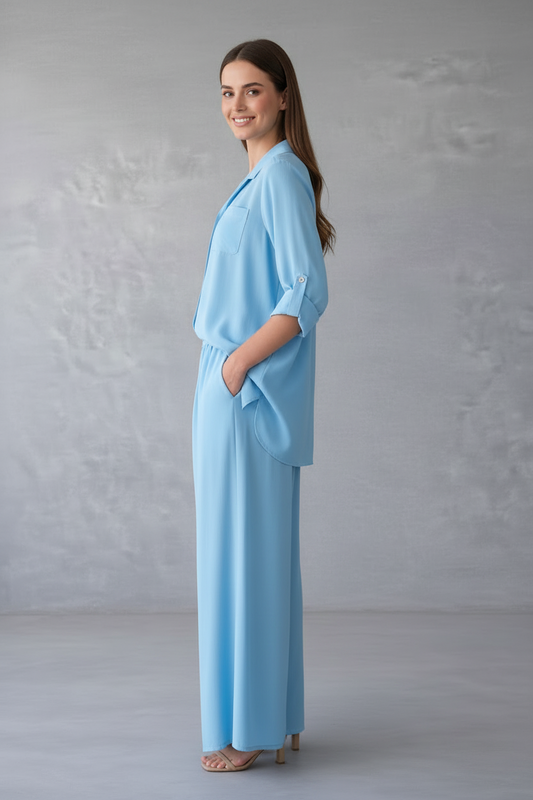 Woman wearing a light blue outfit against a gray background