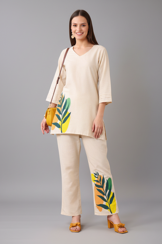 Woman wearing a beige outfit with leaf patterns on a gray background