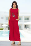 Woman wearing a red outfit with a pool and building in the background