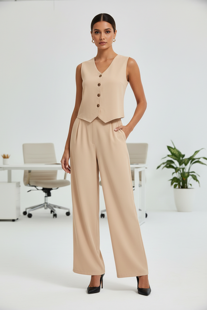 Woman wearing a beige vest and pants in an office setting