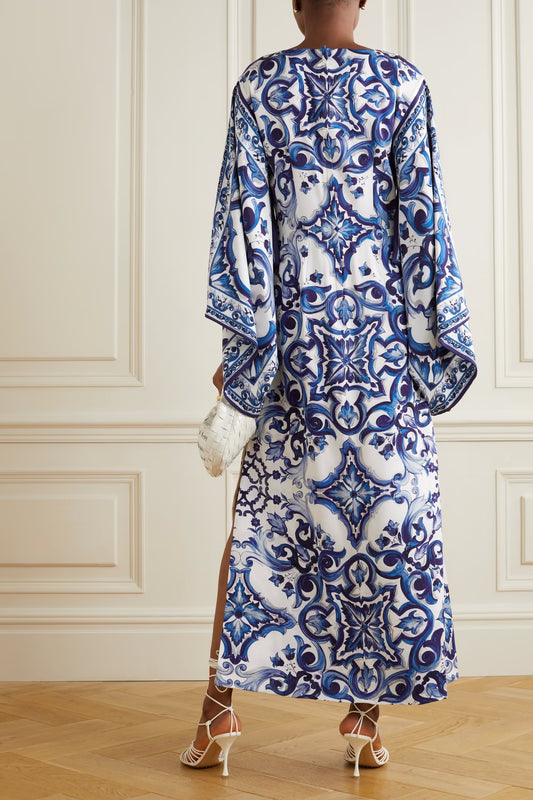 Back view of a luxury printed silk kaftan featuring flowy sleeves and elegant blue patterns
