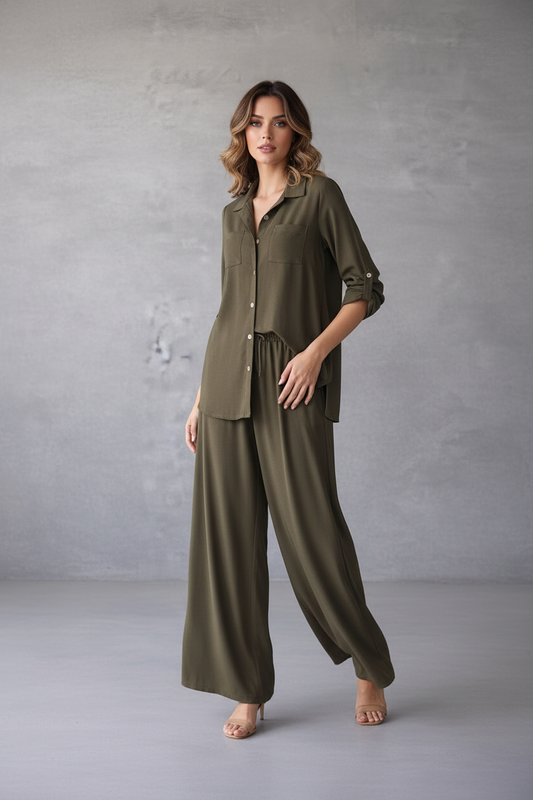 Woman wearing an olive green outfit against a gray background