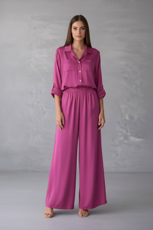 Woman wearing a pink outfit against a gray background