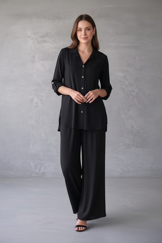 Woman wearing a black outfit against a gray background