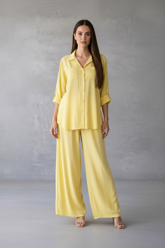 Woman wearing a yellow outfit against a gray background