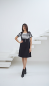 "Model wearing black suspender skirt with striped t-shirt co-ord set, styled with ankle boots – front view."
