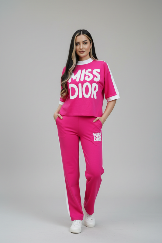 Woman wearing a pink 'Miss Dior' outfit on a gray background
