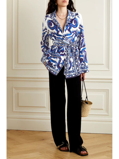 blue printed satin shirt, satin shirt for women, blue baroque print shirt, white and blue shirt, women’s designer shirt, printed formal shirt, button-down shirt for women, belted shirt for women, statement shirt, elegant office wear, smart casual shirt, premium satin shirt, stylish western wear, party wear shirt, PoshBella fashion