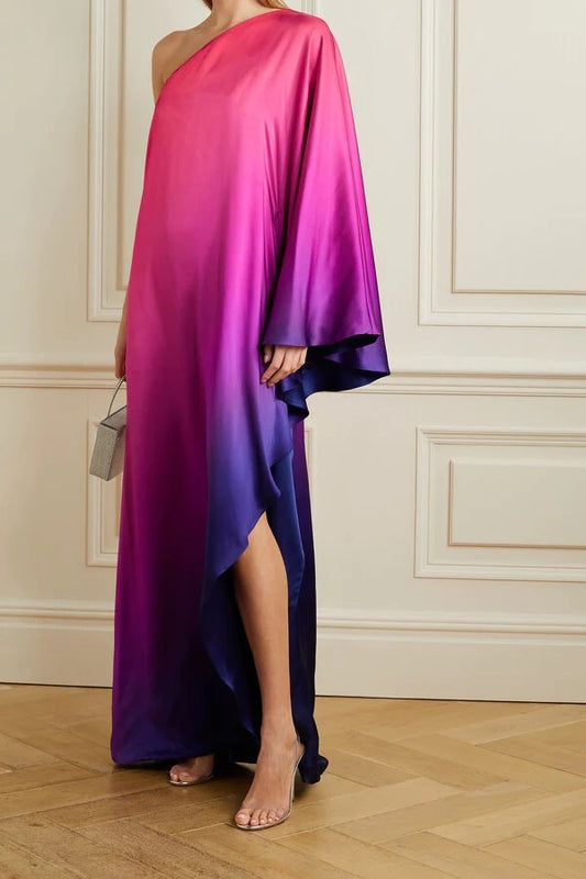 Woman wearing a gradient dress from pink to purple in an elegant interior setting.