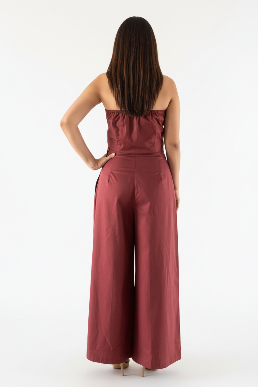 Woman wearing a red jumpsuit on a white background