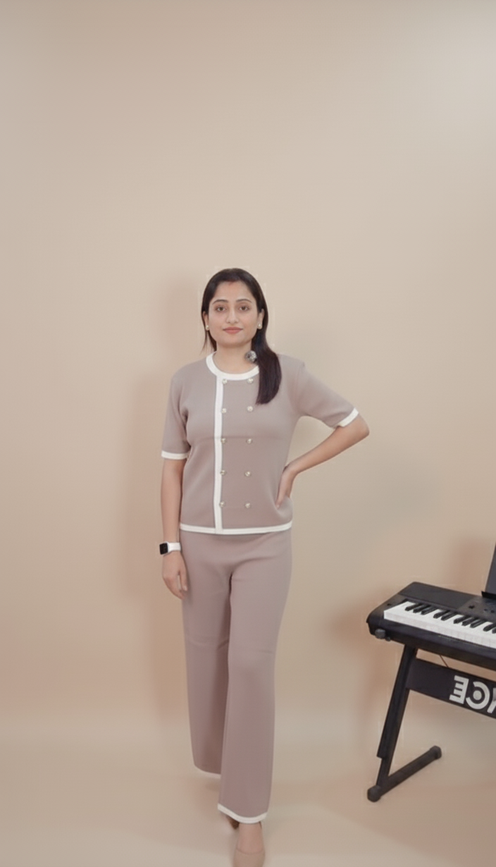 Woman in a gray uniform standing next to a keyboard against a beige wall