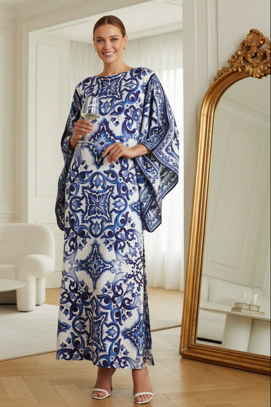 Woman wearing a blue and white organza silk kaftan dress with intricate tile-inspired prints