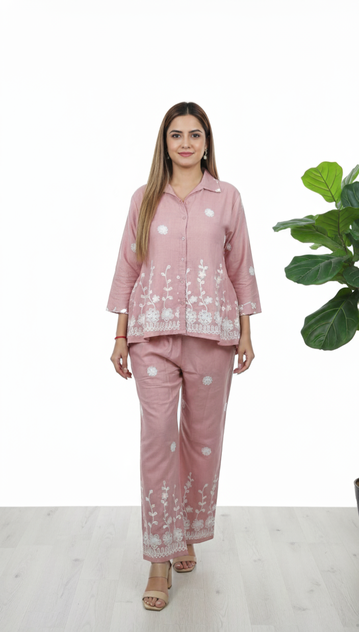 Woman wearing blush pink cotton co-ord set with white floral embroidery