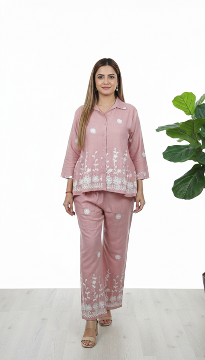 Woman wearing blush pink cotton co-ord set with white floral embroidery