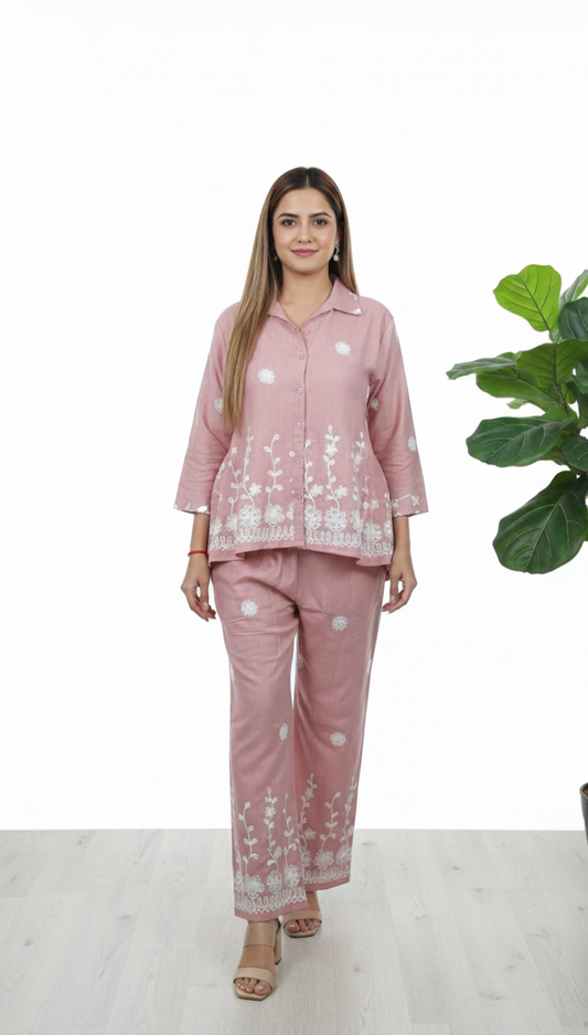 Woman wearing blush pink cotton co-ord set with white floral embroidery