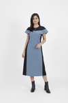 Woman wearing a blue and black dress on a white background