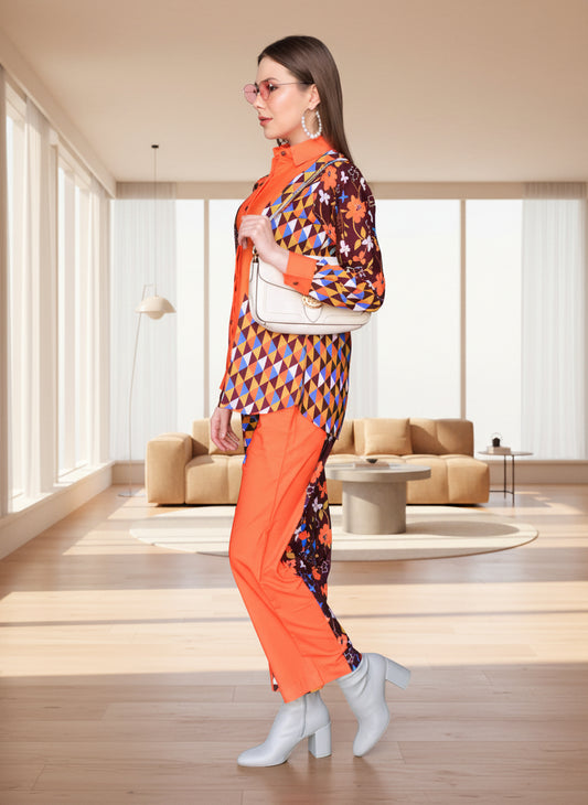 Woman wearing vibrant orange geometric cotton co-ord set from PoshBella, styled with white boots and a chic handbag
