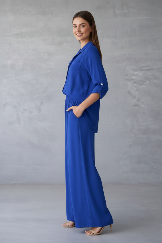 Woman wearing a blue outfit against a gray background