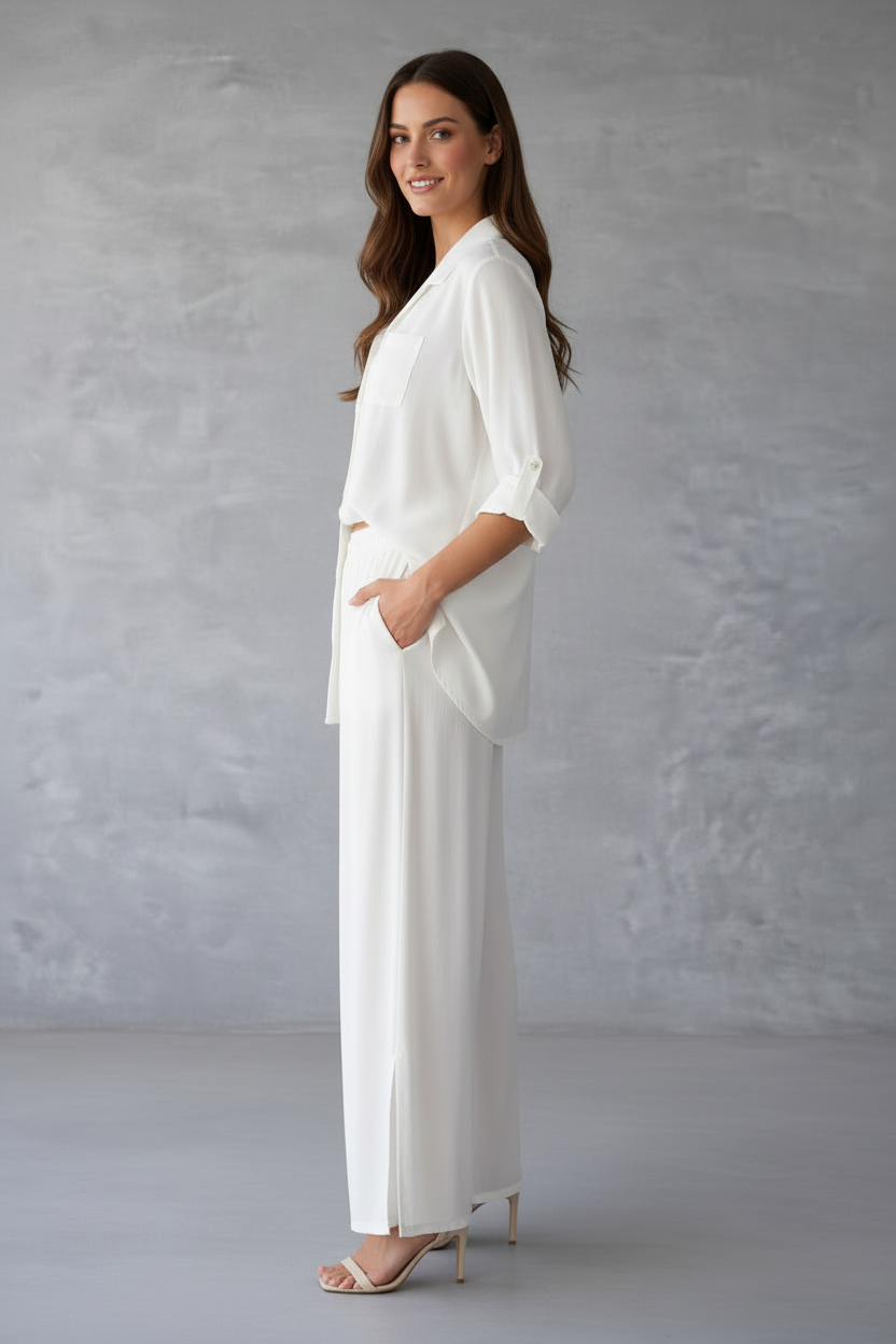 Woman wearing a white outfit against a gray background
