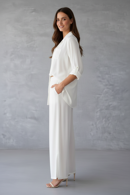 Woman wearing a white outfit against a gray background