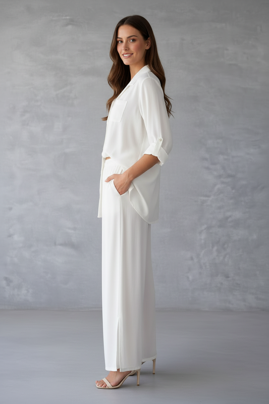 Woman wearing a white outfit against a gray background