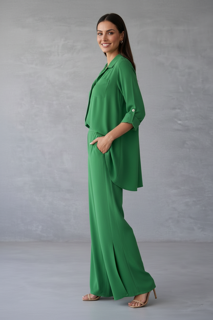 Woman wearing a green outfit against a gray background