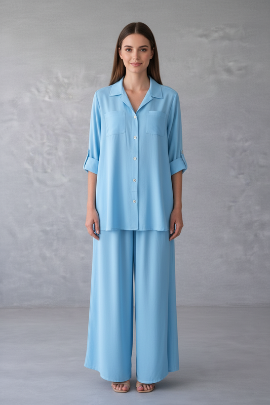 Woman wearing a light blue outfit against a gray background