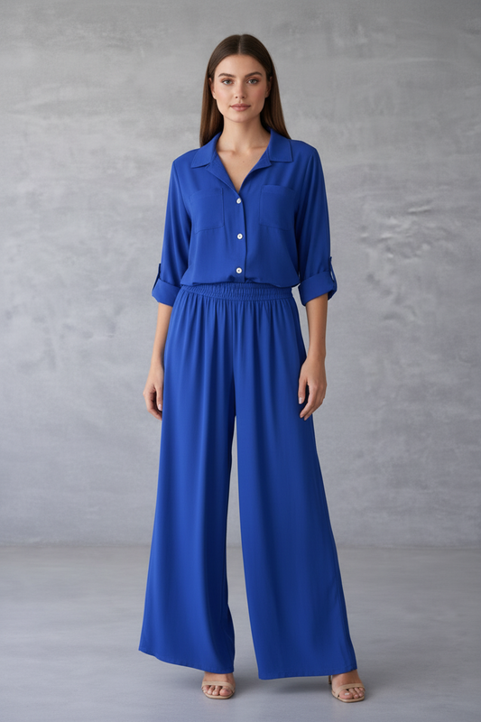 Woman wearing a blue outfit against a gray background