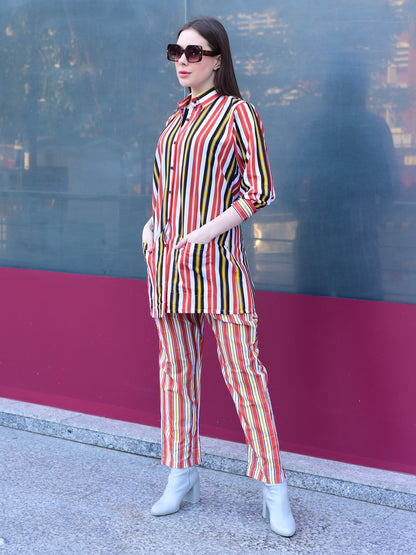 Woman in a colorful striped outfit standing against a reflective surface, stylish and versatile co-ord set for women 