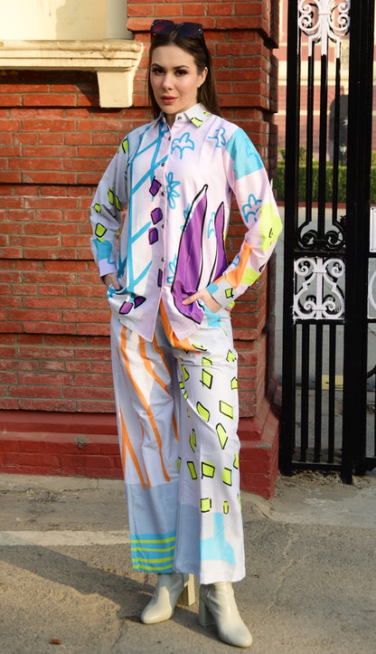 Person wearing a colorful outfit with abstract patterns in an urban setting, stylish women’s co-ord.